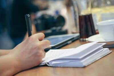 Woman journaling for year-end reflection and goal setting